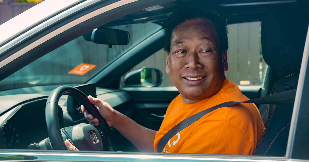 A HopSkipDrive CareDriver seated in a vehicle